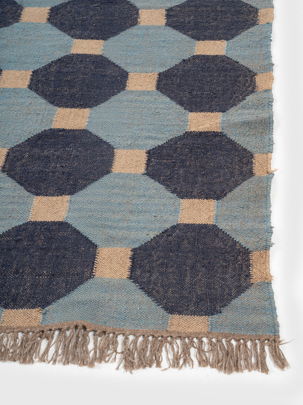 The Denim Grid Kilim close-up showing the wool weave and geometric motif