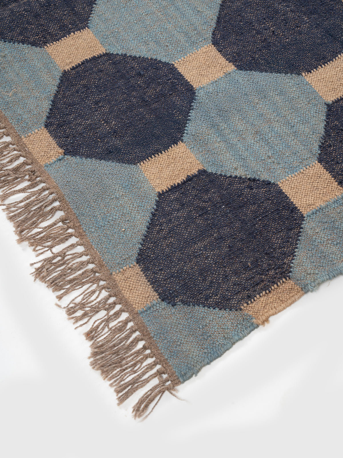 The Denim Grid Kilim wool rug styled in a living room interior