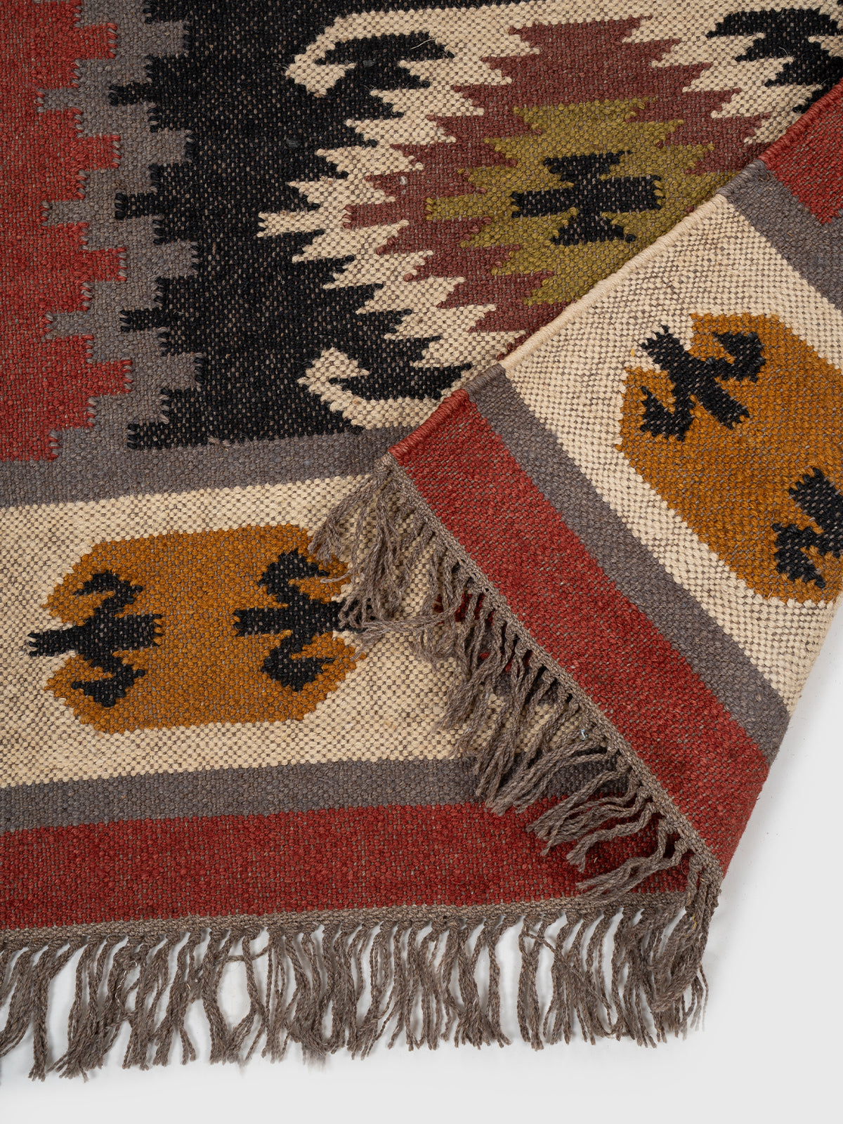 The Ember Diamond Runner detail showing edge binding and wool finishing of the runner