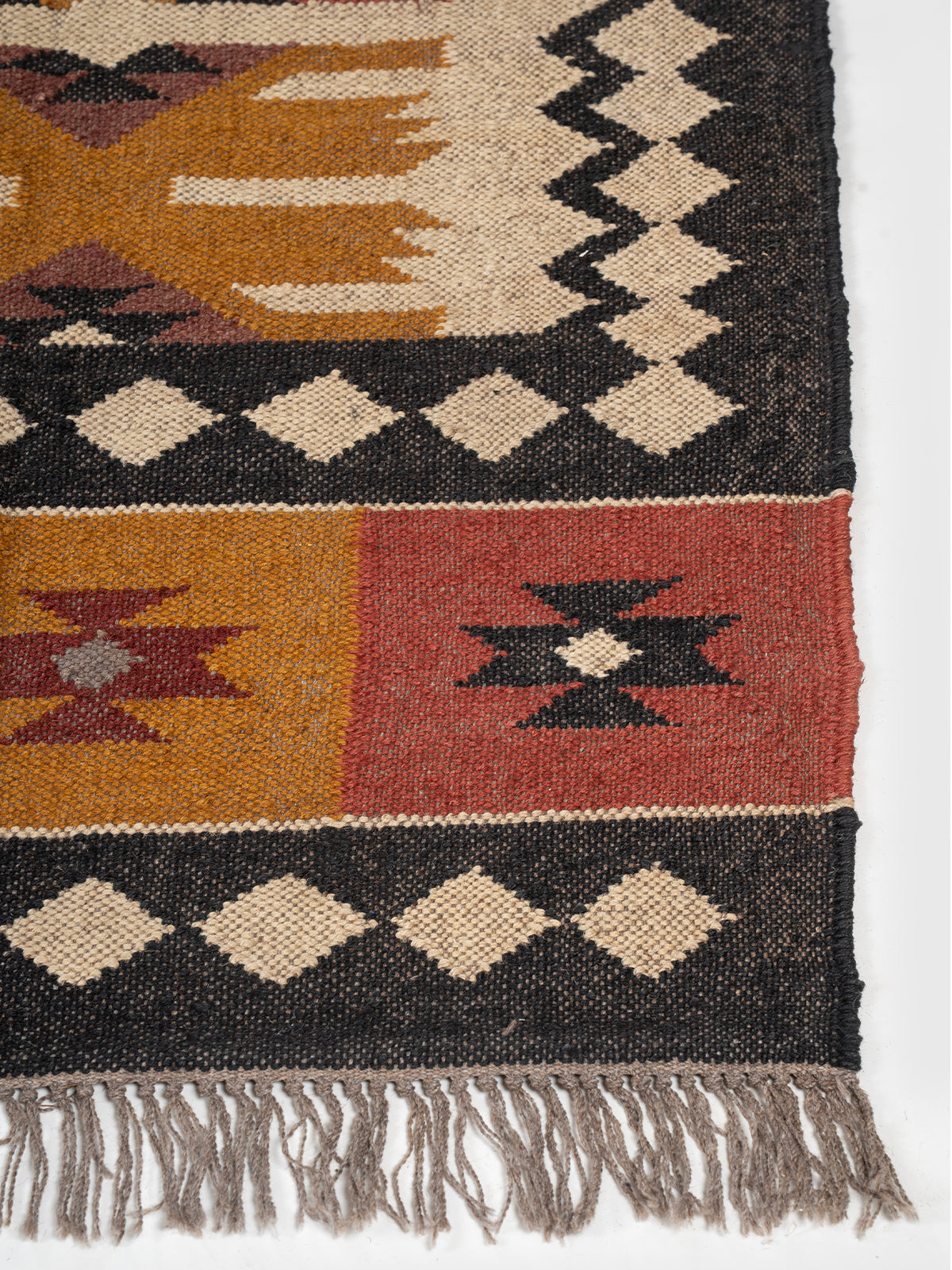 The Iron Grid Rug wool rug styled in a living room interior