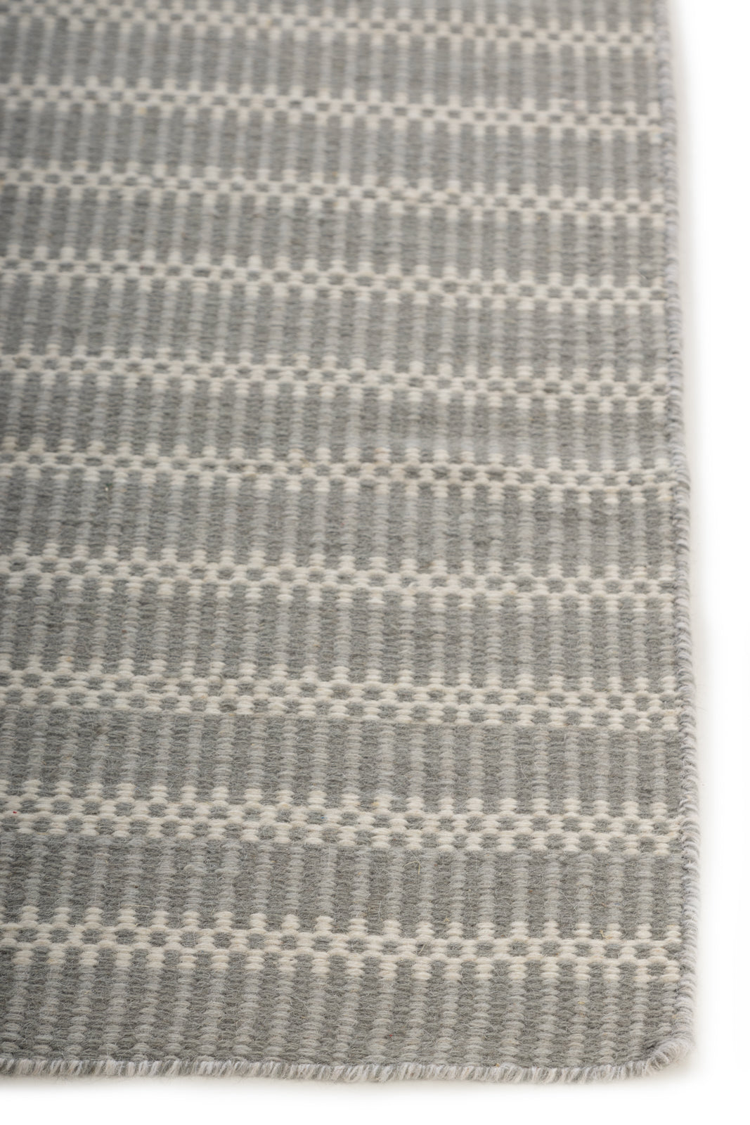 The Linear Calm wool rug styled in a living room interior