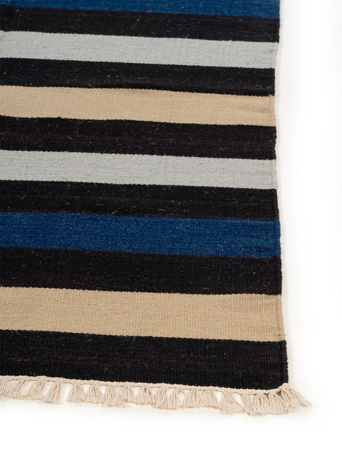 The Midnight Stripes Rug wool rug styled in a living room interior