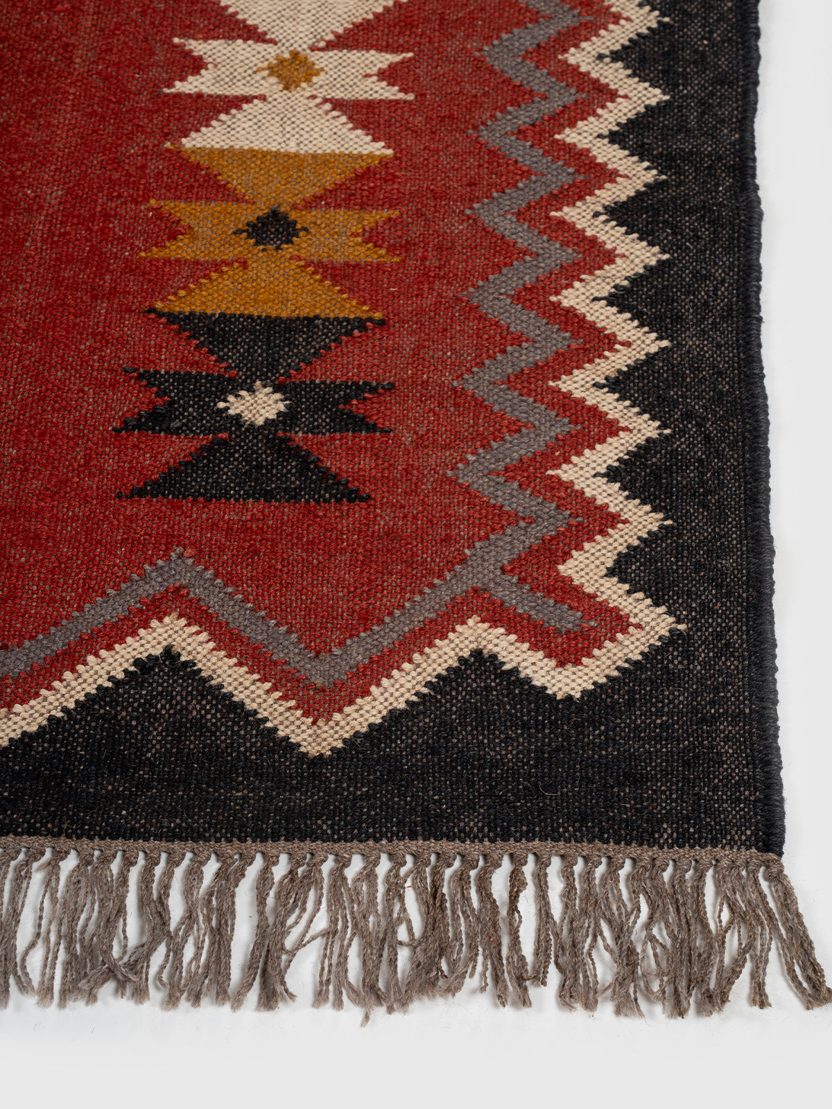 The Nomadic Star Kilim wool rug styled in a living room interior