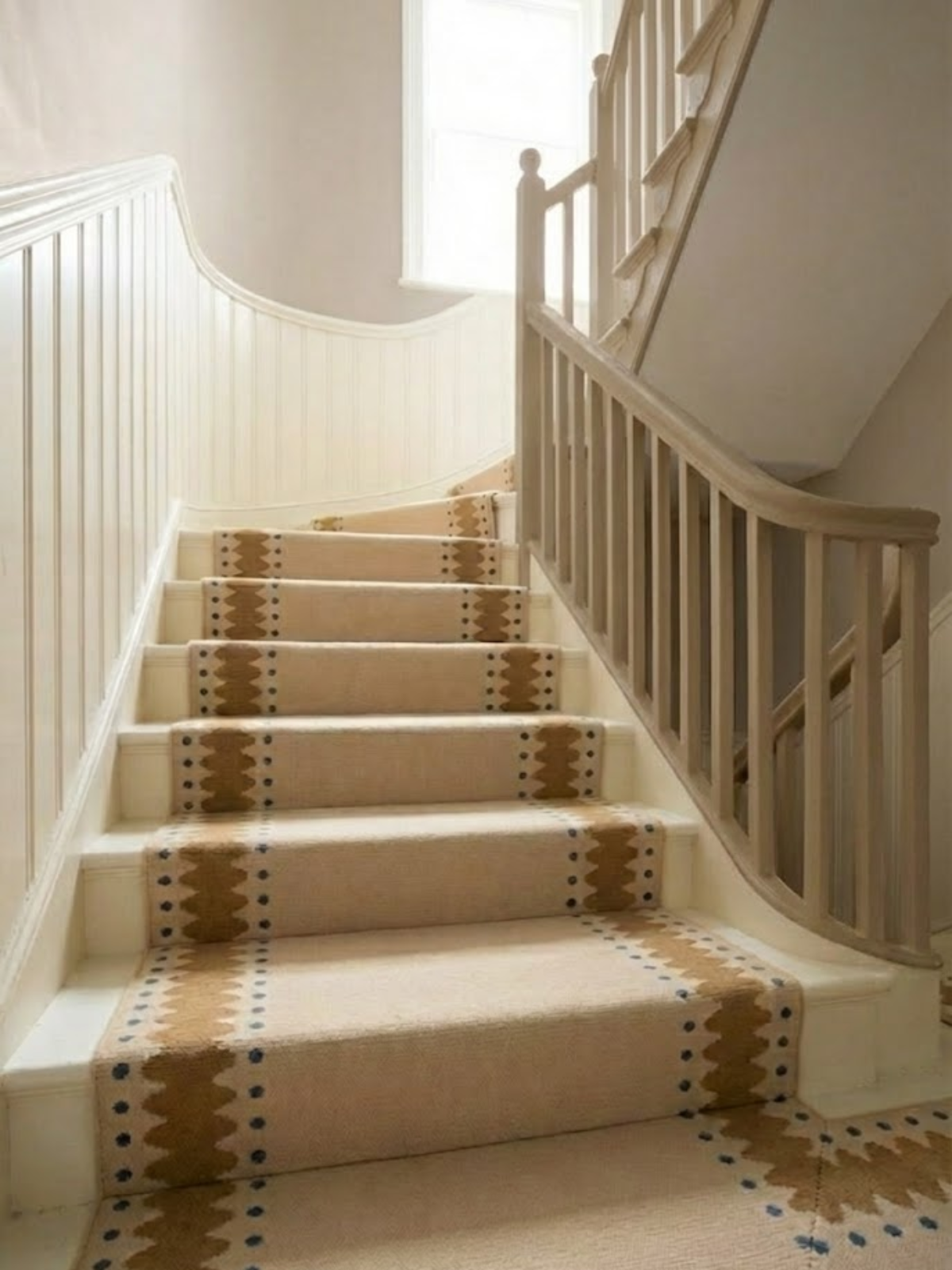 The Pebble Trail Runner wool stair runner styled on a staircase in a designed interior