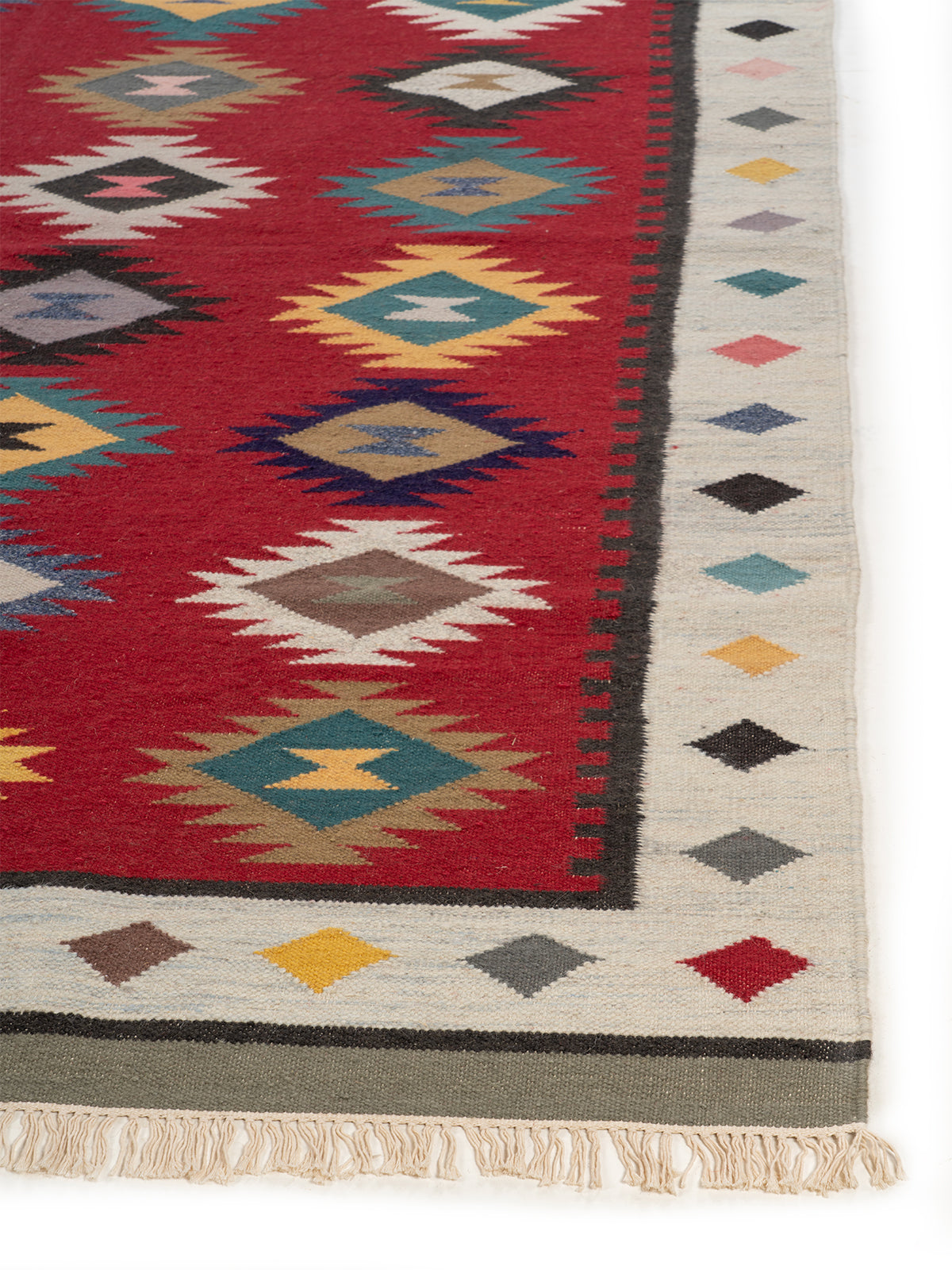 The Ruby Diamond Rug wool rug styled in a living room interior