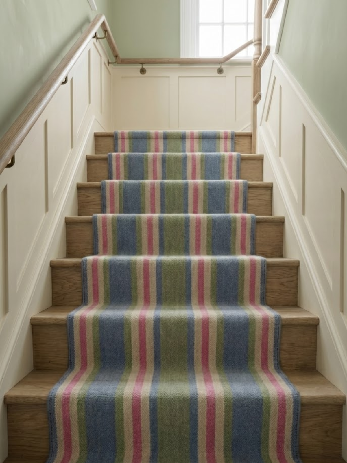 The Sky Blush Runner cotton stair runner styled on a staircase in a designed interior