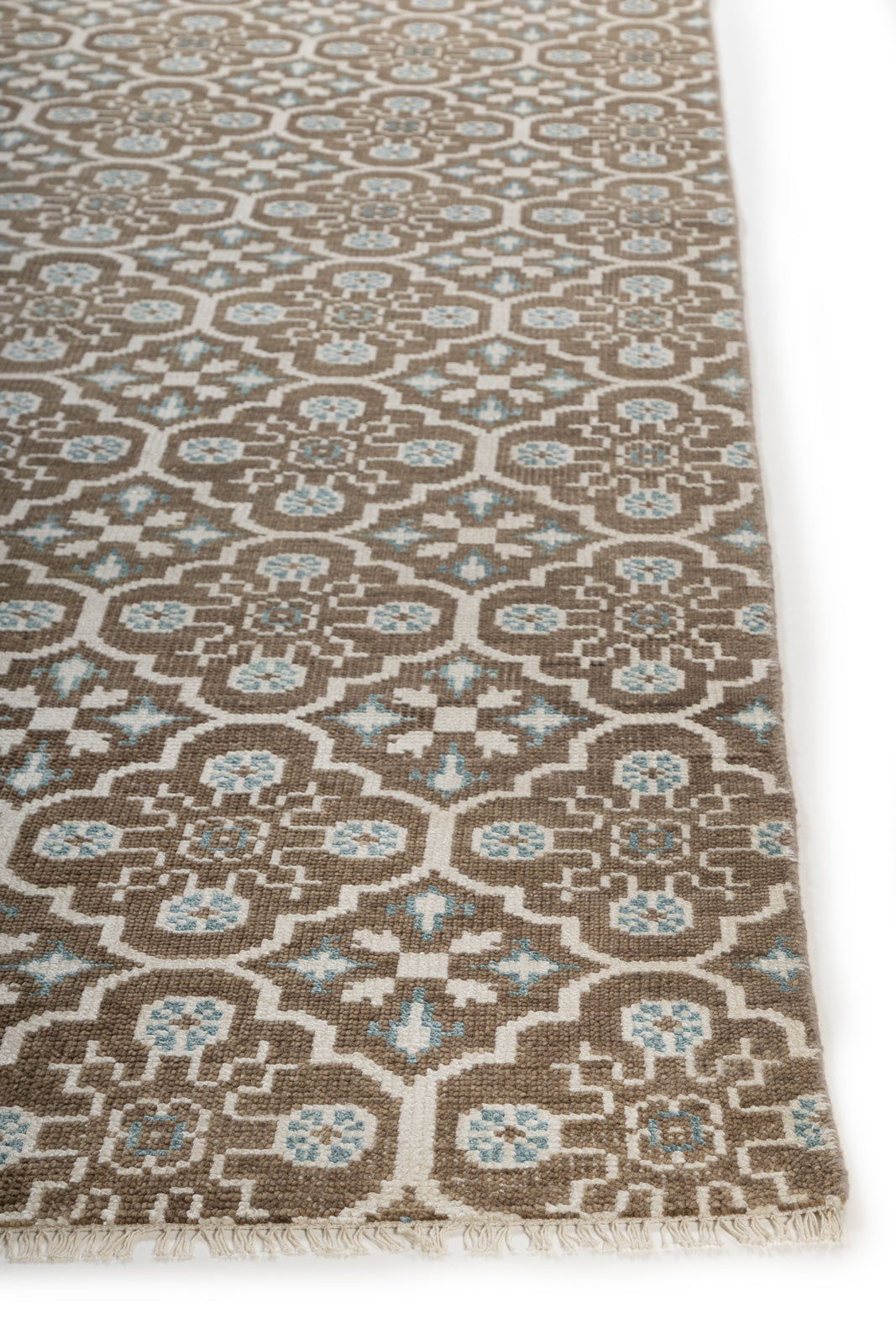 The Still Loom wool rug styled in a living room interior