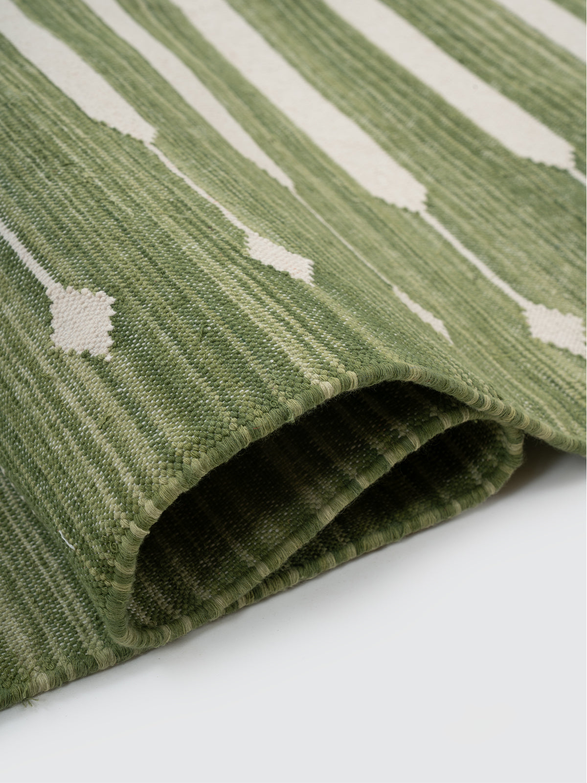 The Subtle Bloom Runner-Green - cotton runner laid in a hallway view