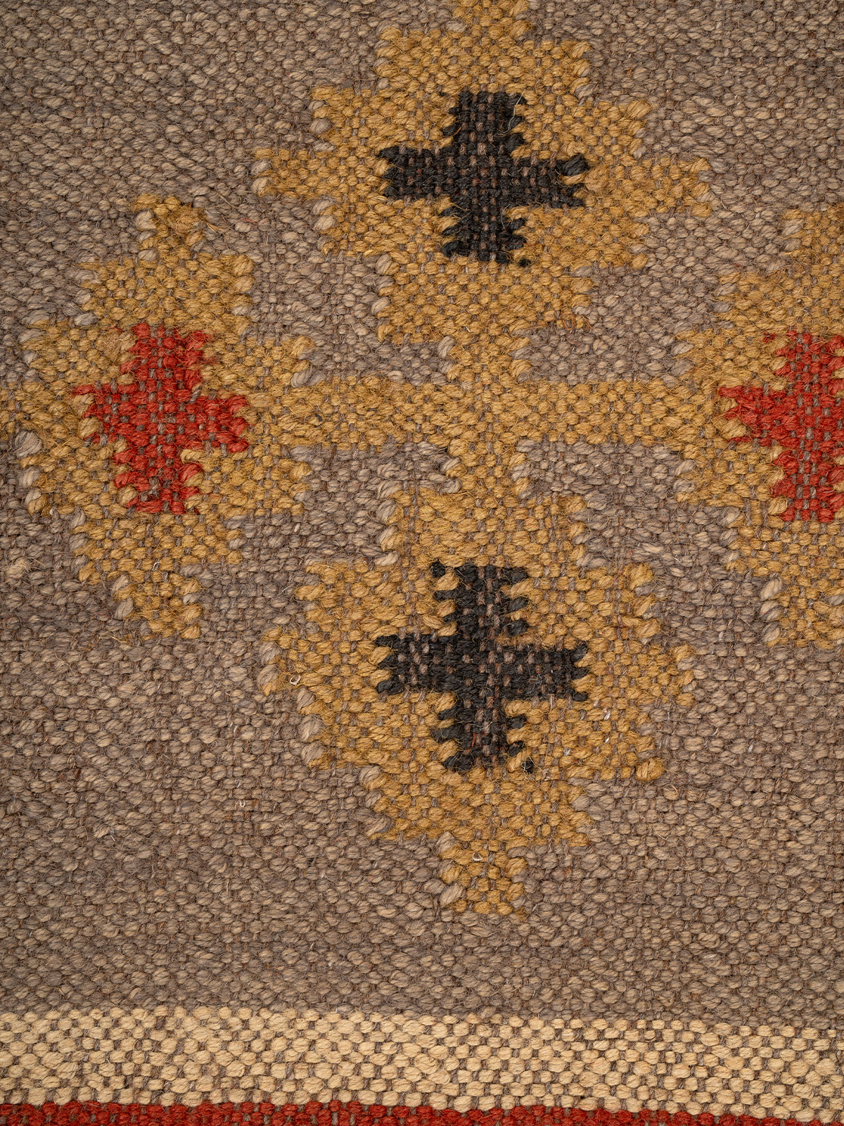 The Fortress Shield Kilim close-up showing the wool weave and geometric motif