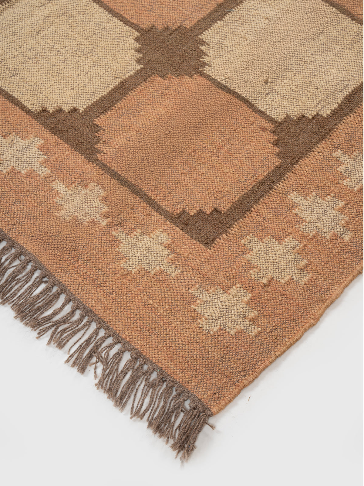 The Warm Lattice Rug close-up showing the wool weave and geometric motif