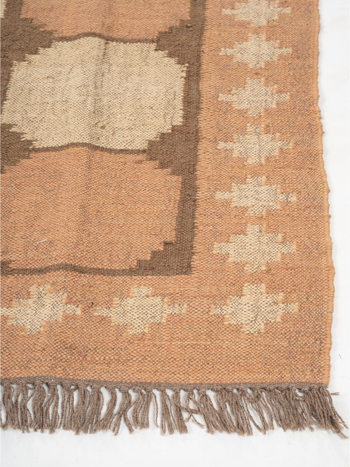 The Warm Lattice Rug wool rug styled in a living room interior