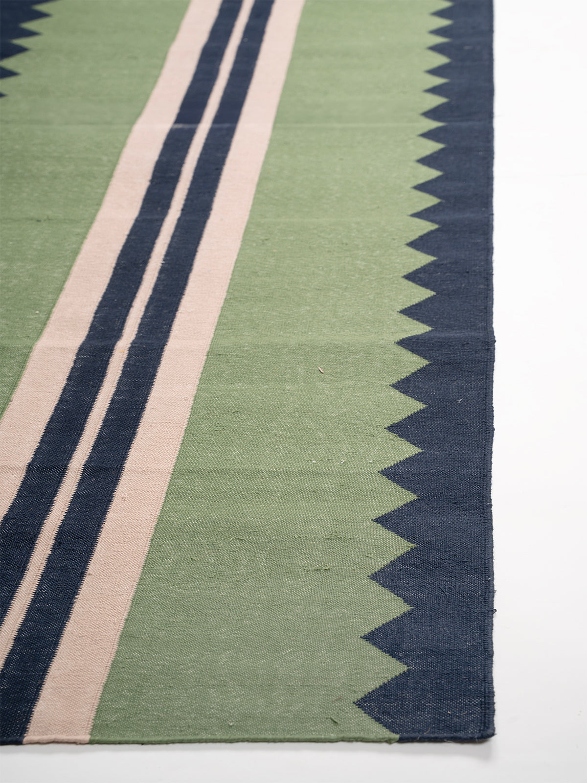 The Zigzag Trail Runner- Muted moss - cotton runner laid in a hallway view