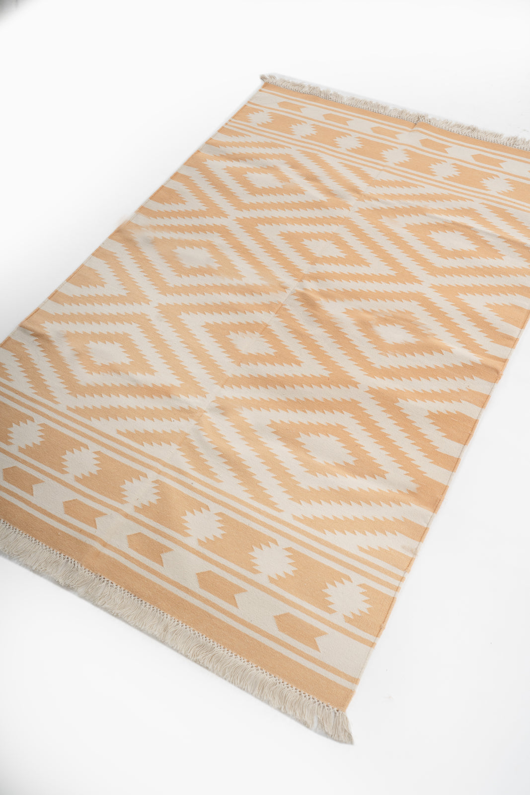 Tribal Chevron Reversible Cotton Flatweave Rug cotton rug styled in a living room interior