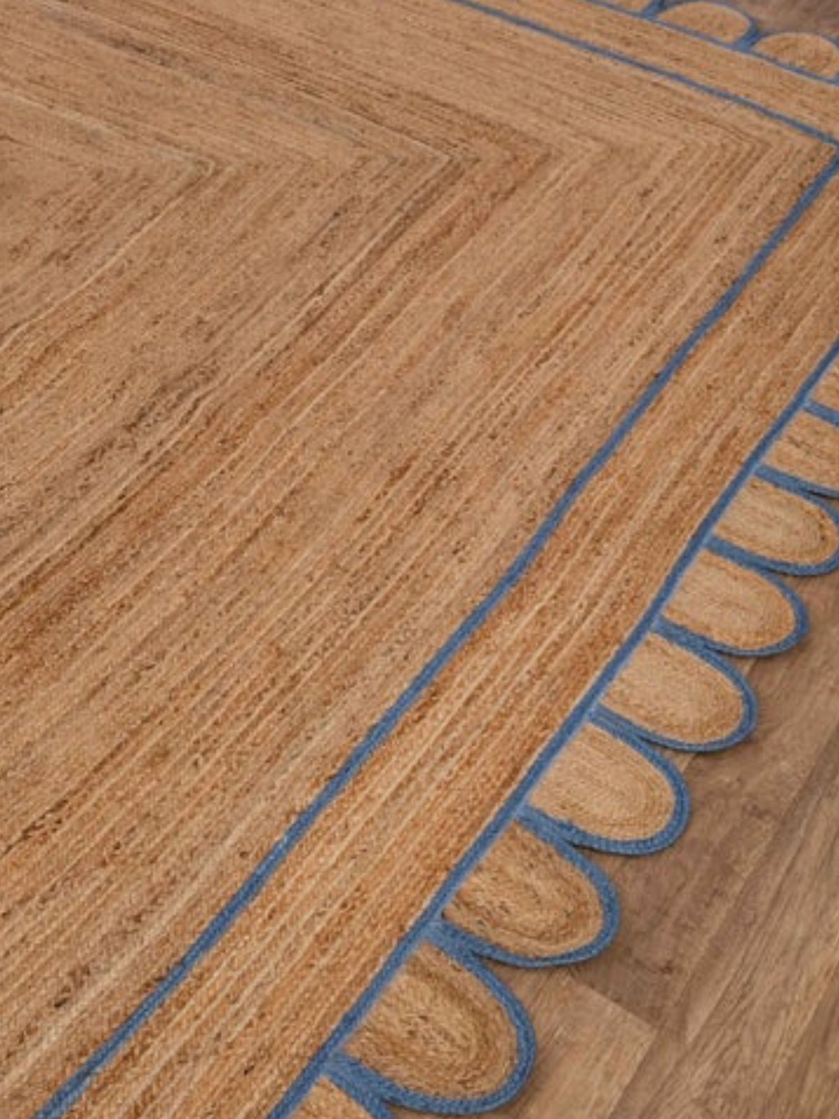 Tripoli scalloped jute braided rug-Blue jute rug styled in a living room interior
