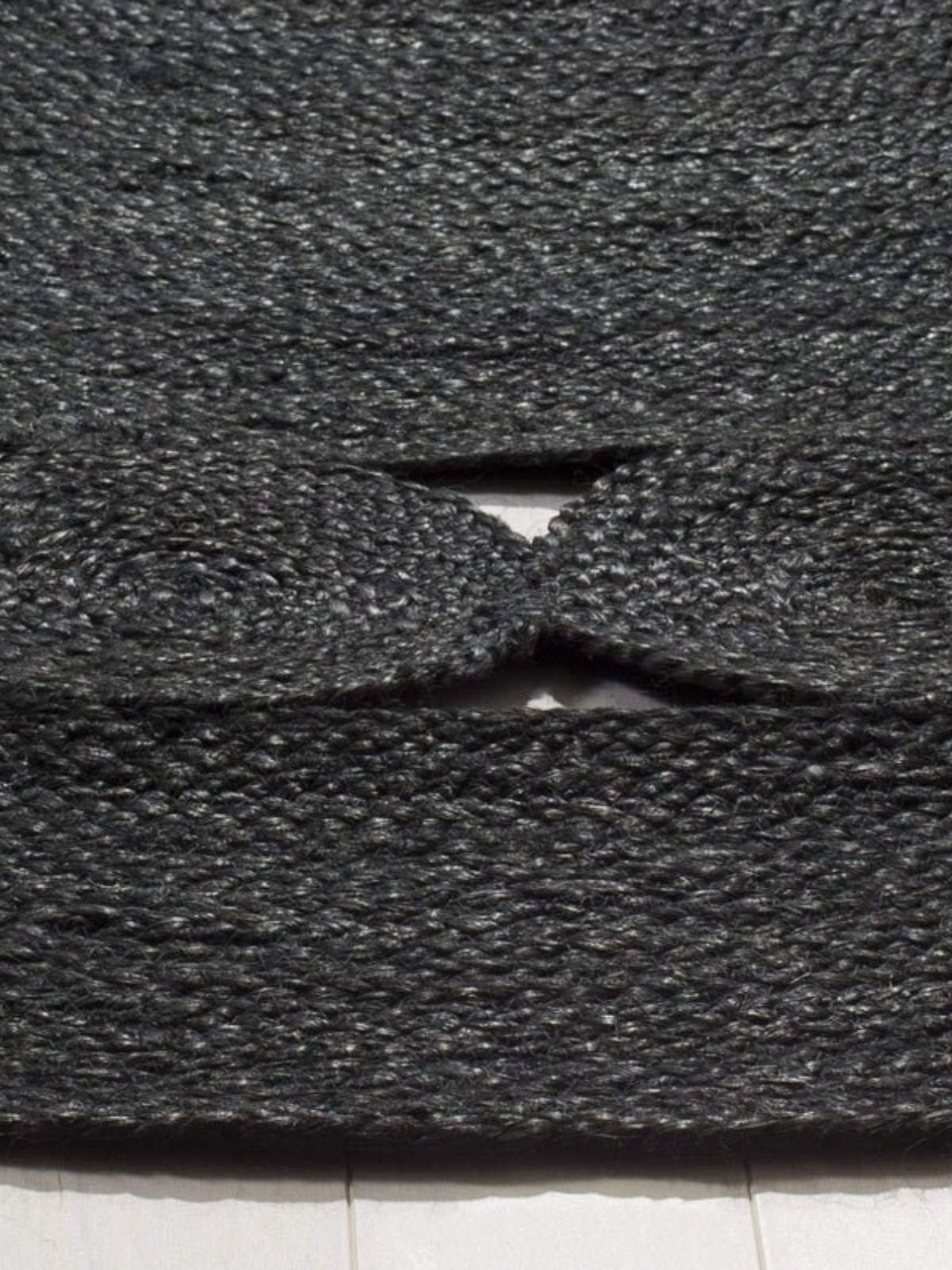 Tunis round jute rug-Black detail showing the textured jute surface and finishing
