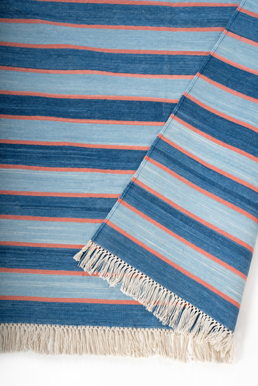 Varanasi Sunset Flatweave Rug detail of the striped cotton surface and edge finishing