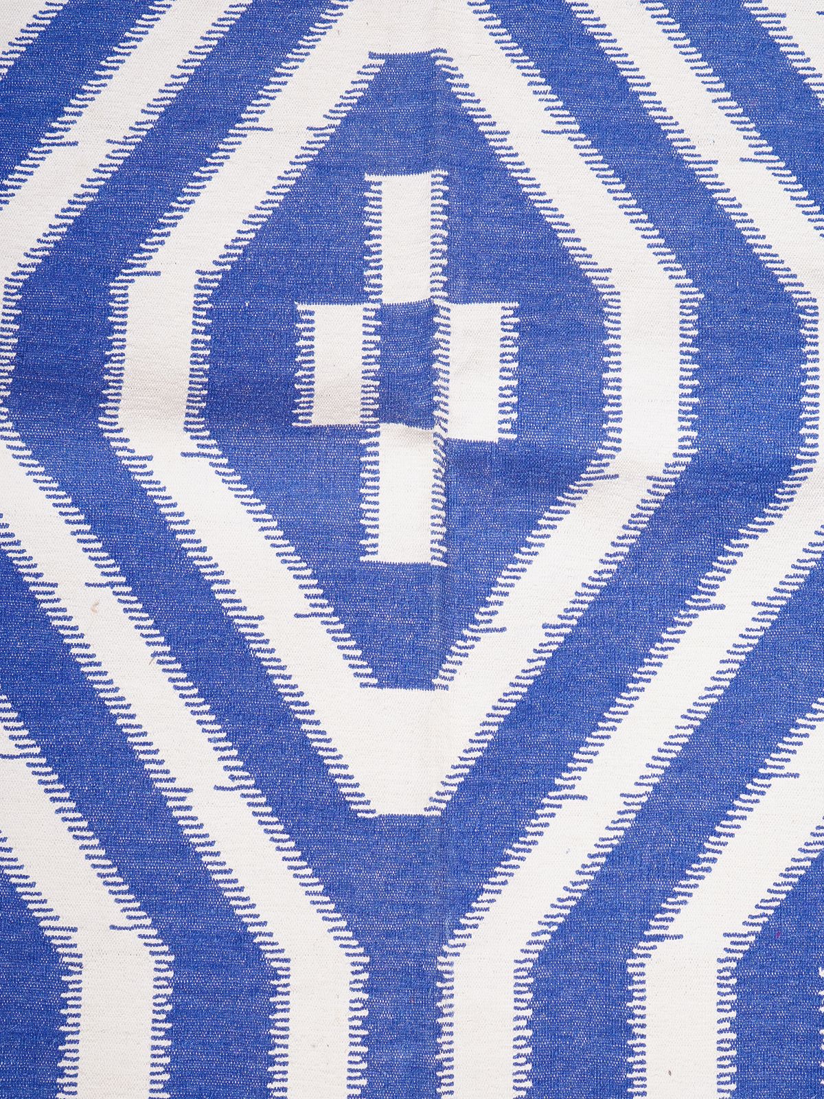 White Wave Ikat Flatweave Rug - texture detail showing cotton surface