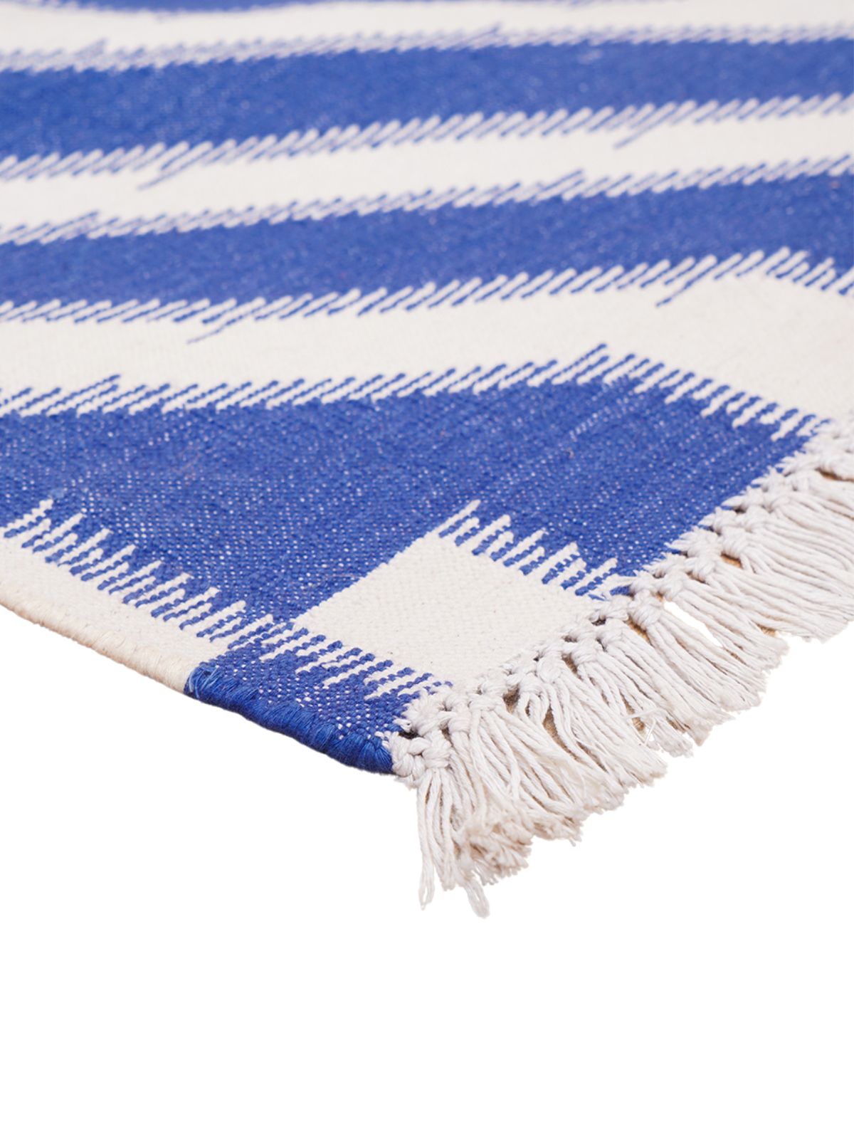 White Wave Ikat Flatweave Rug cotton rug styled in a living room interior