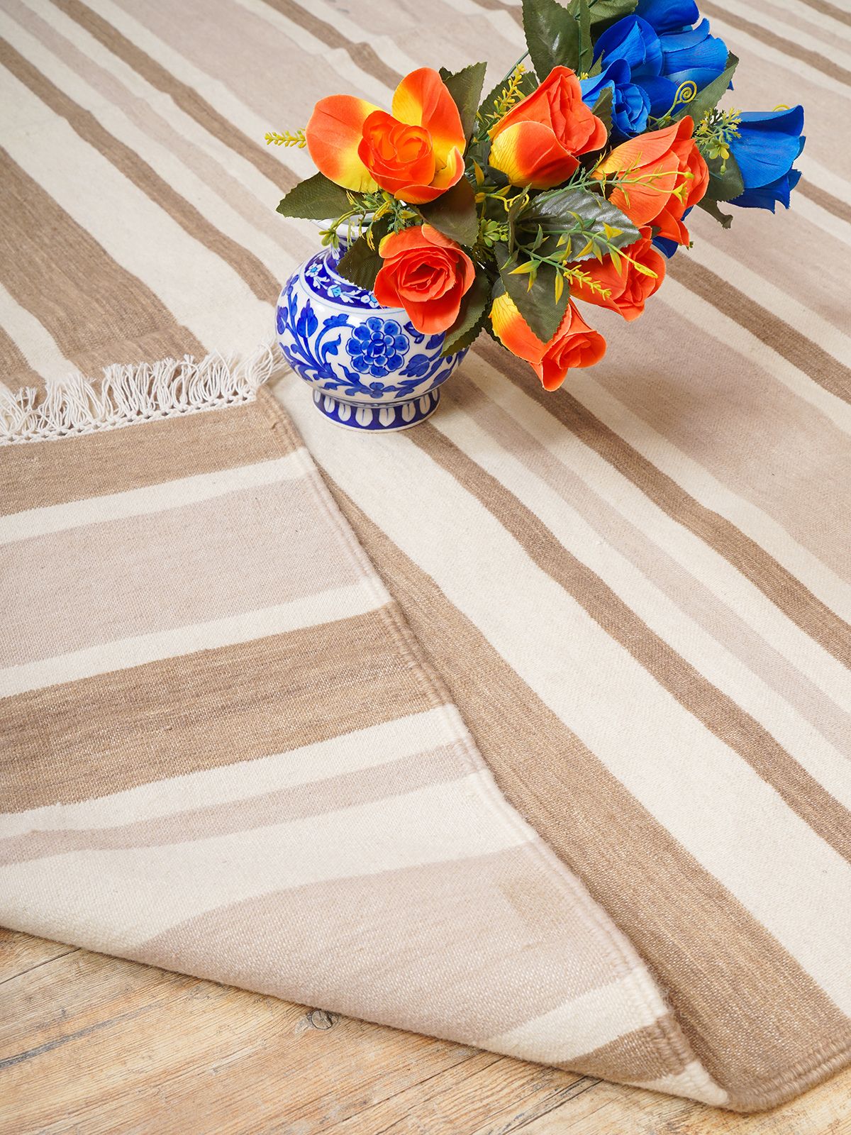 Elevate your living space with our Handwoven Amber Arpeggio Flatweave Rug, a true testament to craftsmanship and timeless design. This luxurious wool rug features a unique irregular stripe pattern, making it the perfect centerpiece for any room.