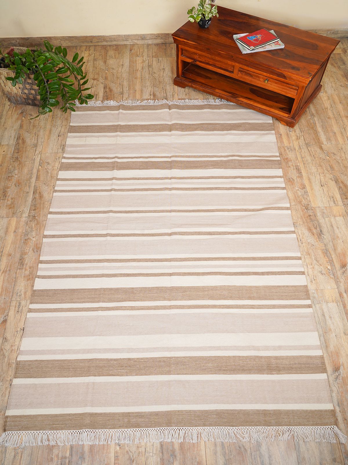 Elevate your living space with our Handwoven Amber Arpeggio Flatweave Rug, a true testament to craftsmanship and timeless design. This luxurious wool rug features a unique irregular stripe pattern, making it the perfect centerpiece for any room.