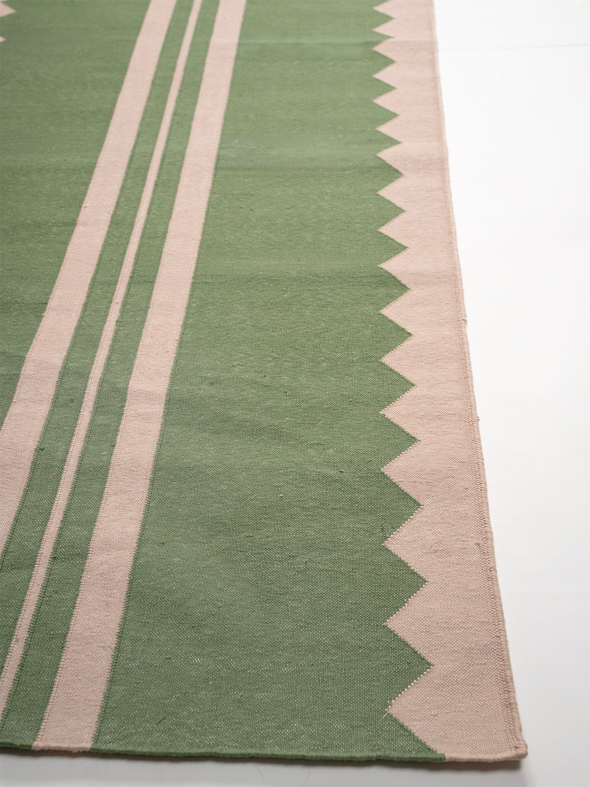 The Zigzag Trail Runner- Basil - cotton runner laid in a hallway view