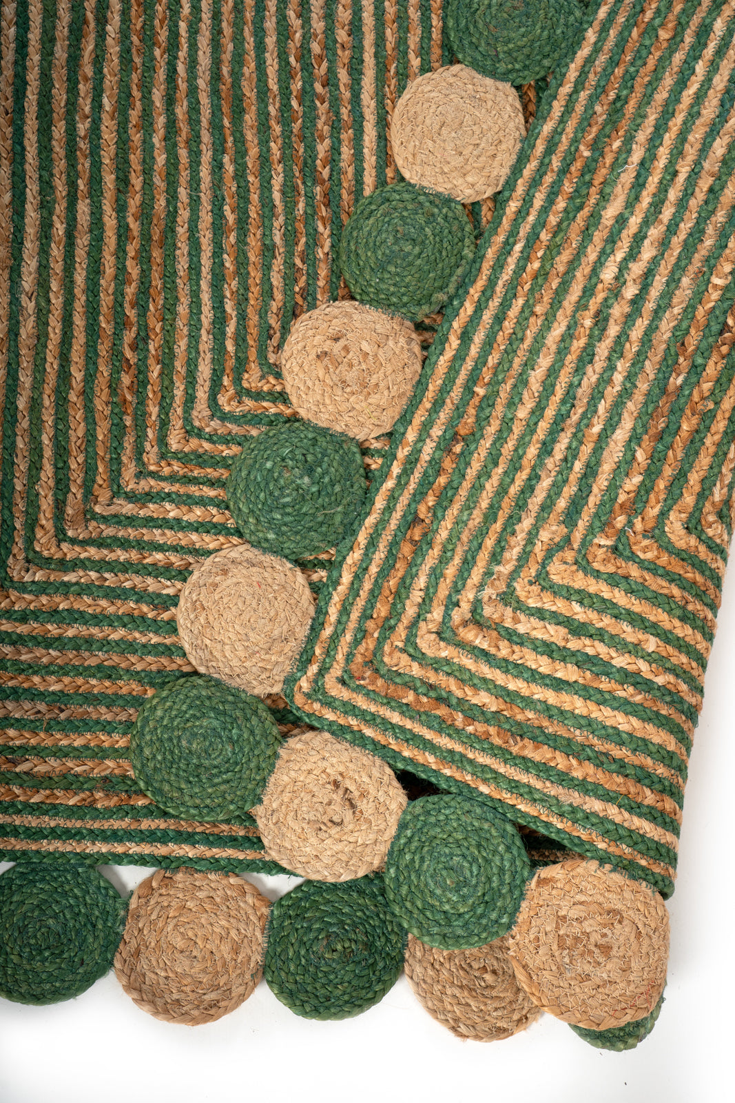Asaba braided area rug detail showing the textured cotton surface and finishing