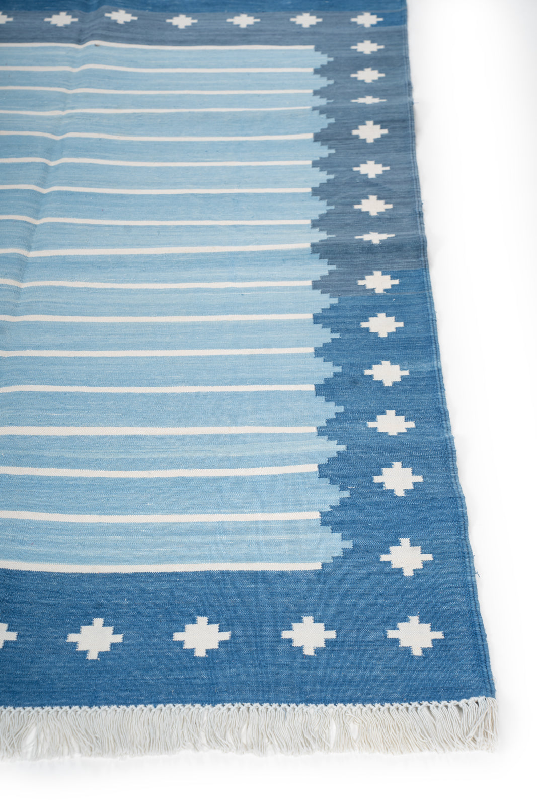 Azure Echoes Flatweave Rug cotton rug styled in a living room interior