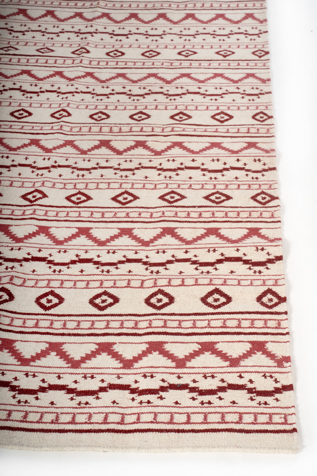 Bhuj Crimson Weave Rug wool rug styled in a living room interior