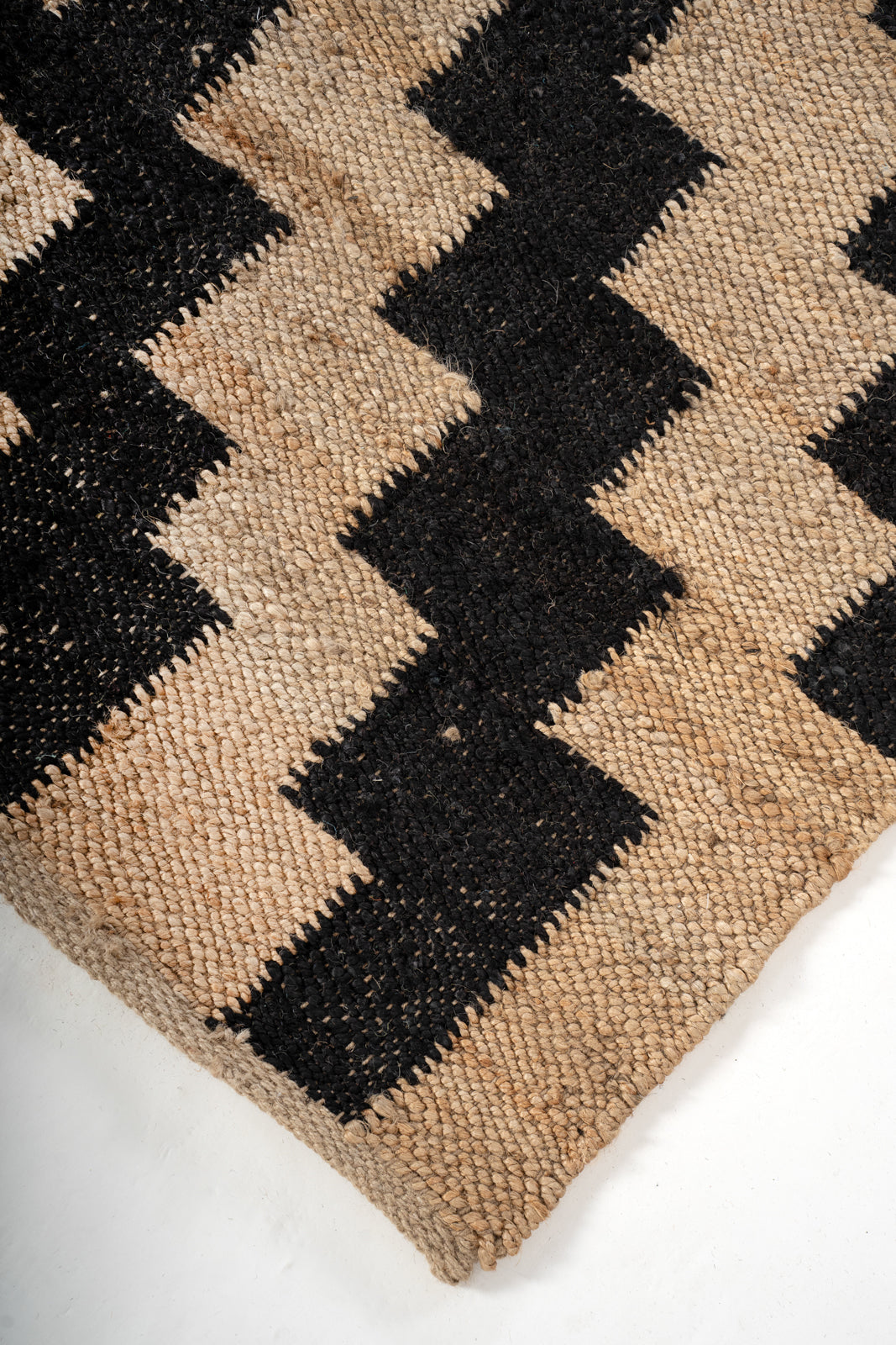 Black Geo Jute Rug close-up showing the jute weave and geometric motif