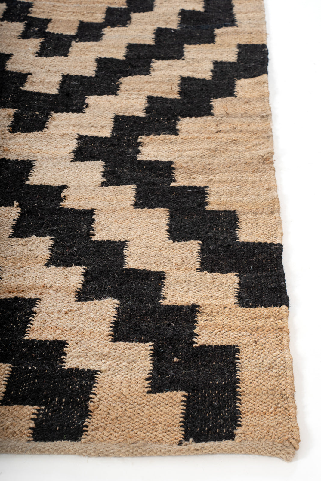 Black Geo Jute Rug jute rug styled in a living room interior
