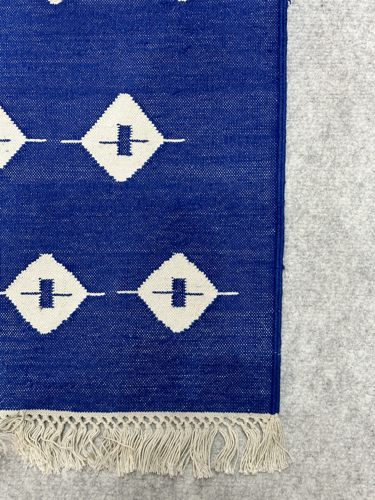 Blue Haven Kilim Cotton Flatweave Rug cotton rug styled in a living room interior