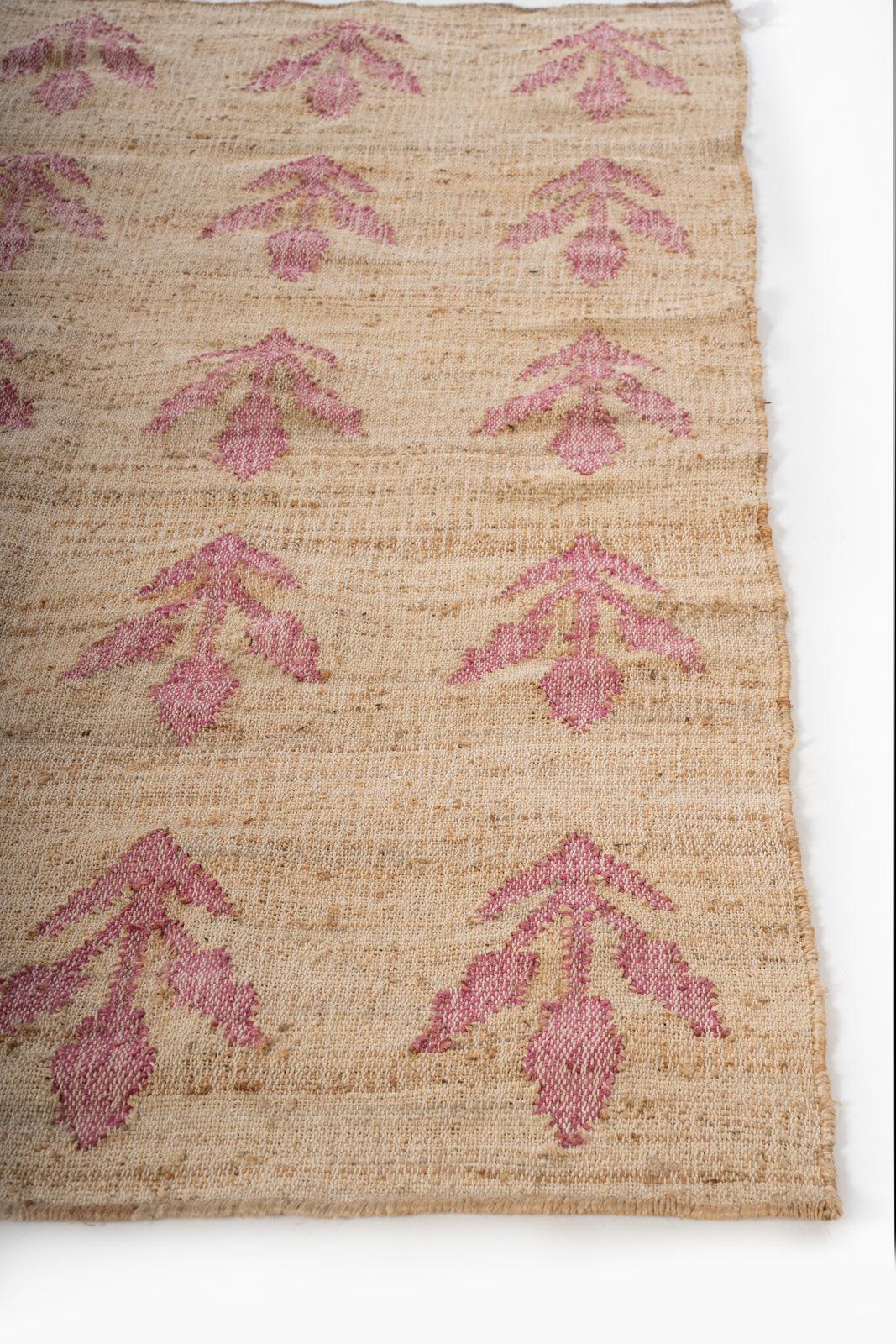 Blush Garden Jute Rug jute rug styled in a living room interior