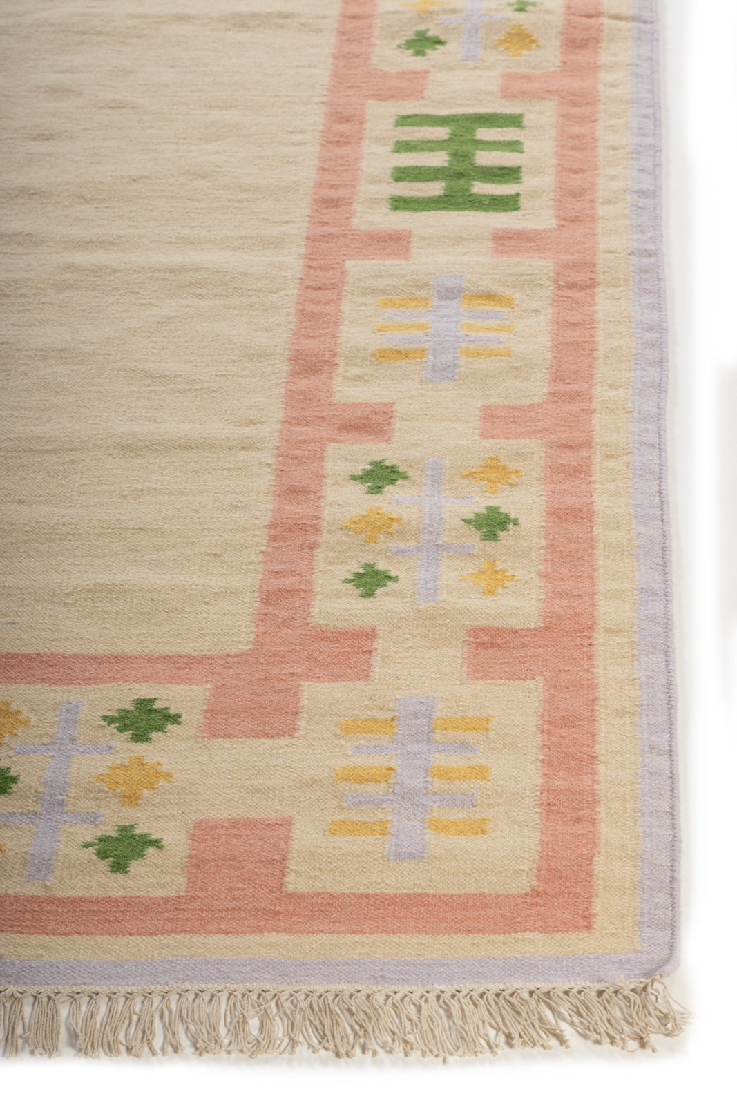 Blush Meadow Border Rug wool rug styled in a living room interior