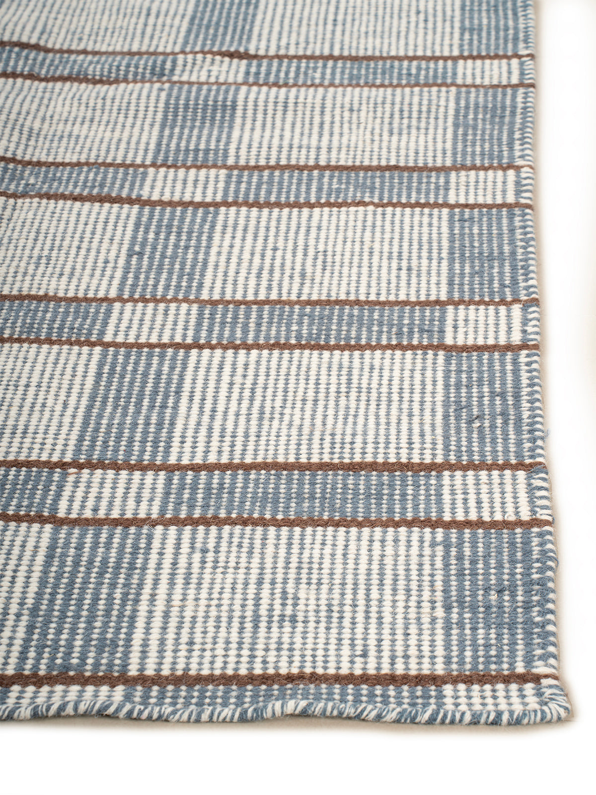 Calm Check Handwoven Wool Rug wool rug styled in a living room interior