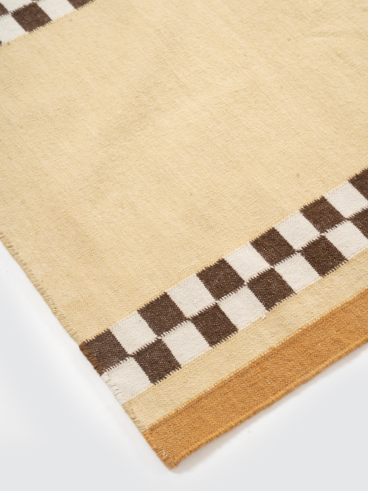 Checkerboard Stream Runner-Yellow close-up showing the cotton weave and geometric surface