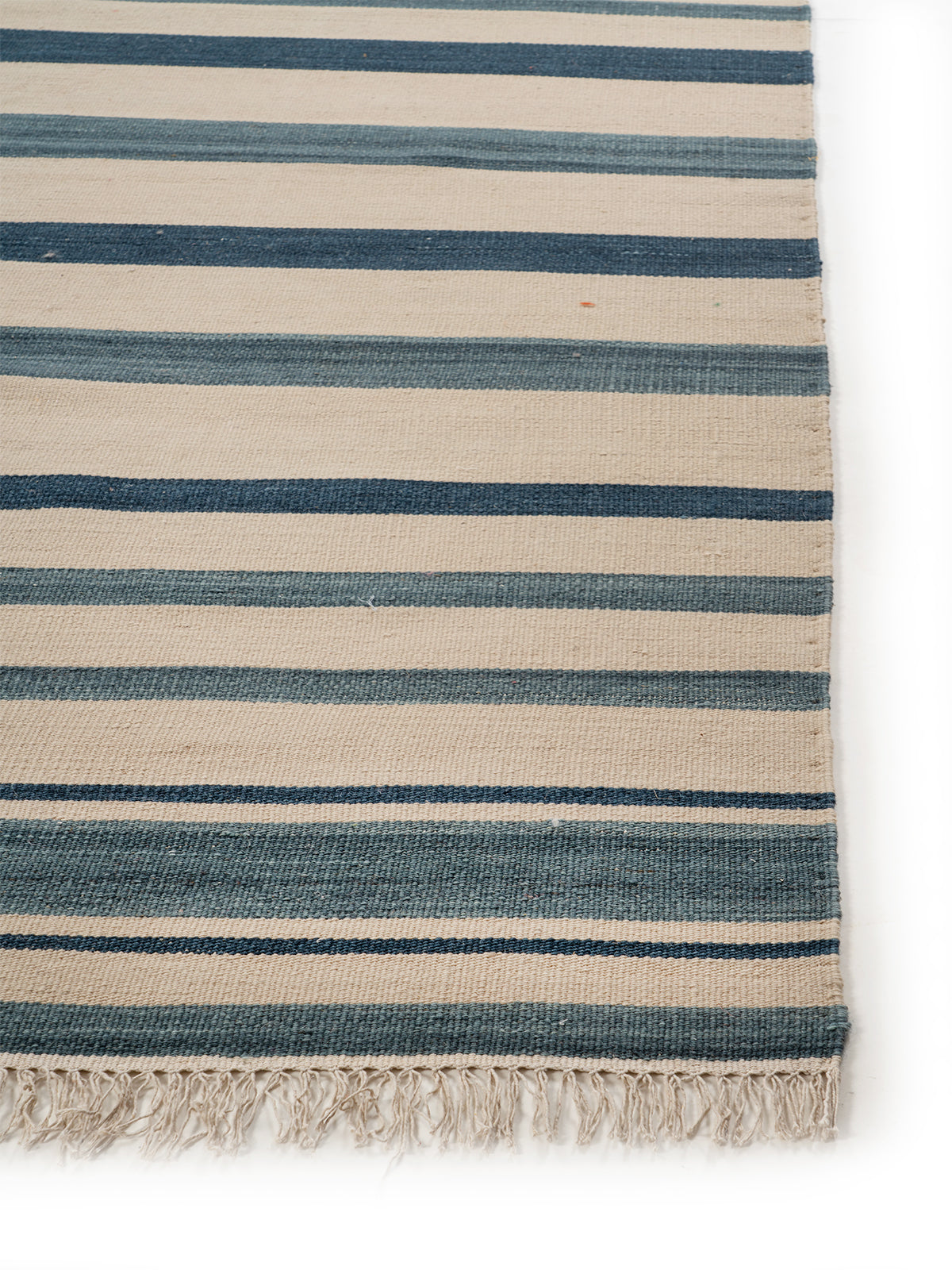 Coastal Stripe Flatweave Rug wool rug styled in a living room interior