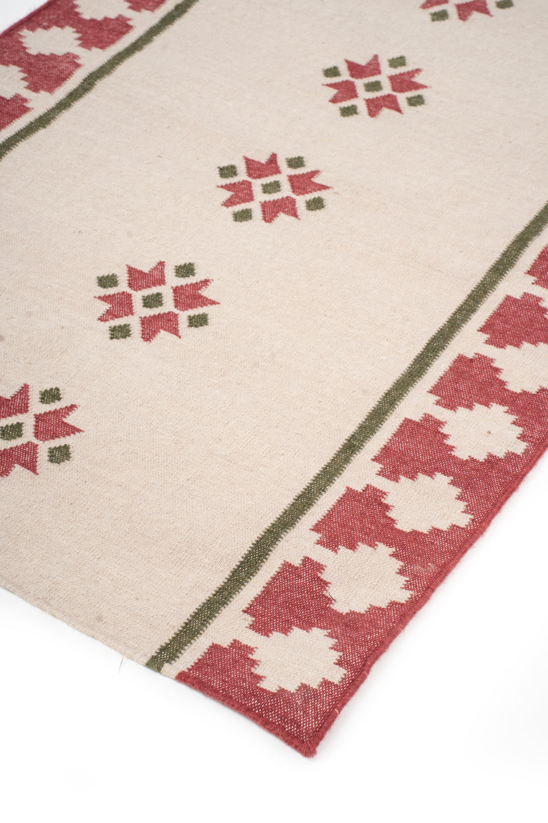 Crimson Crossroads close-up showing the wool weave and geometric motif