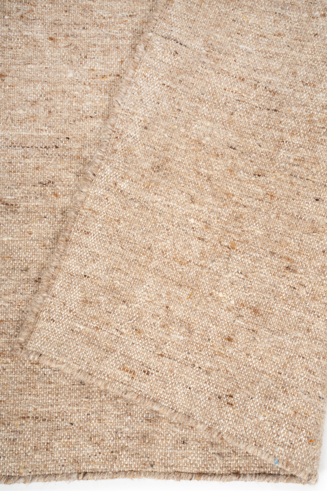 Earthen Essence Beige Wool Rug detail showing the textured wool surface and finishing