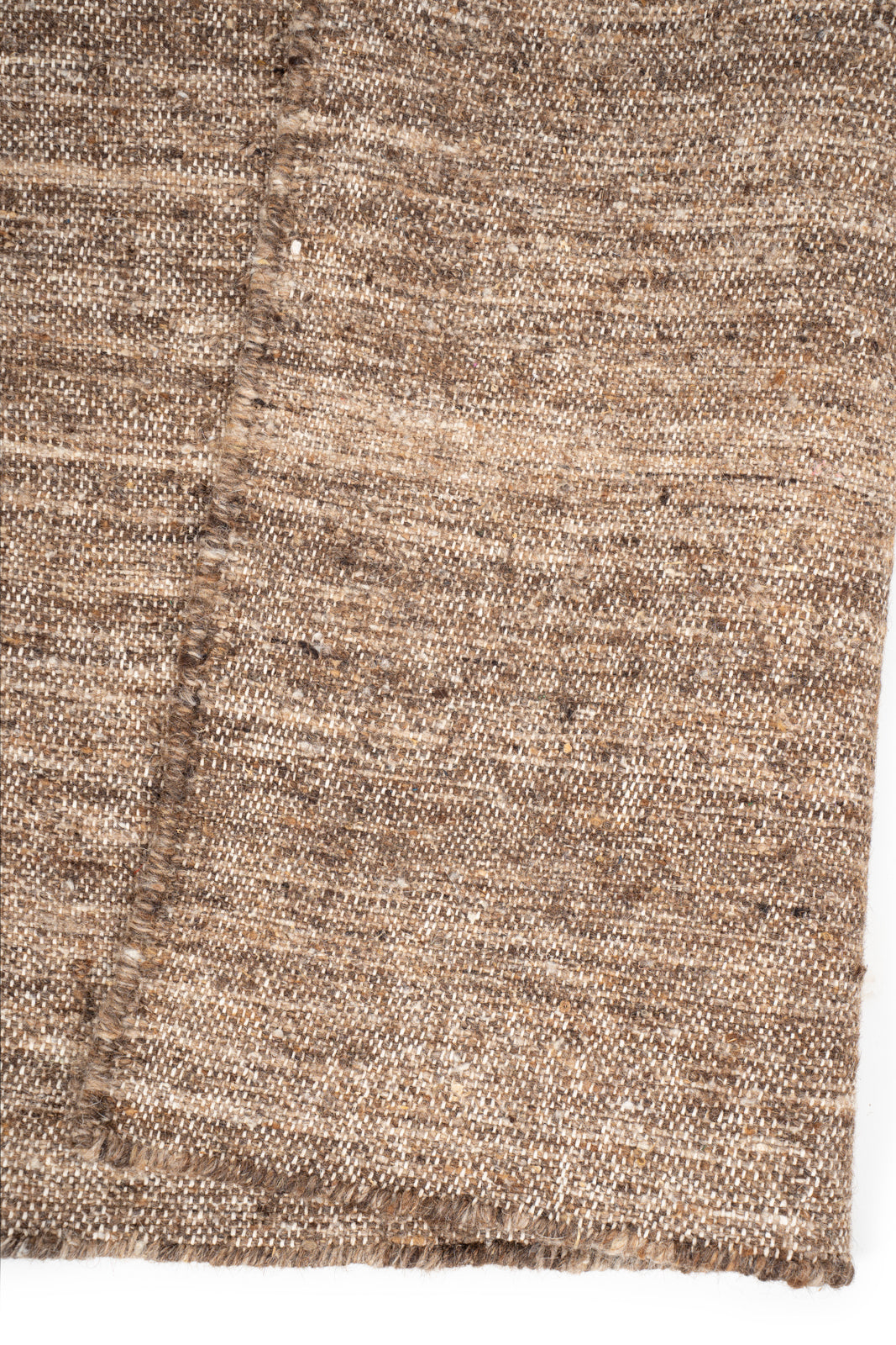 Earthen Essence Brown Wool Rug detail showing the textured wool surface and finishing