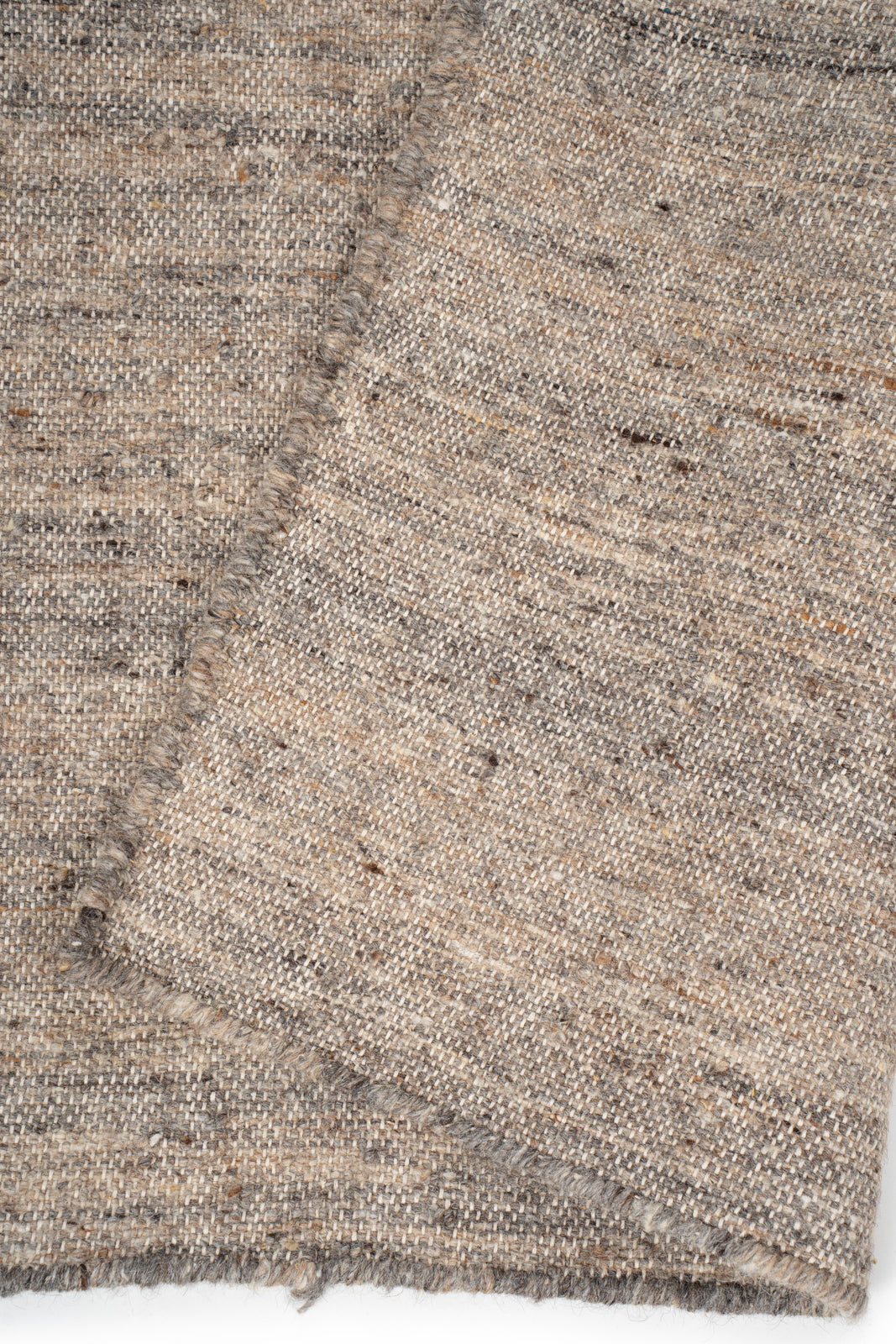 Earthen Essence Burnt Umber Wool Rug detail showing the textured wool surface and finishing