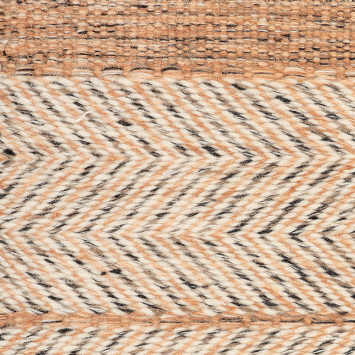 Eira : Ember Rust close-up showing the wool weave and striped pattern