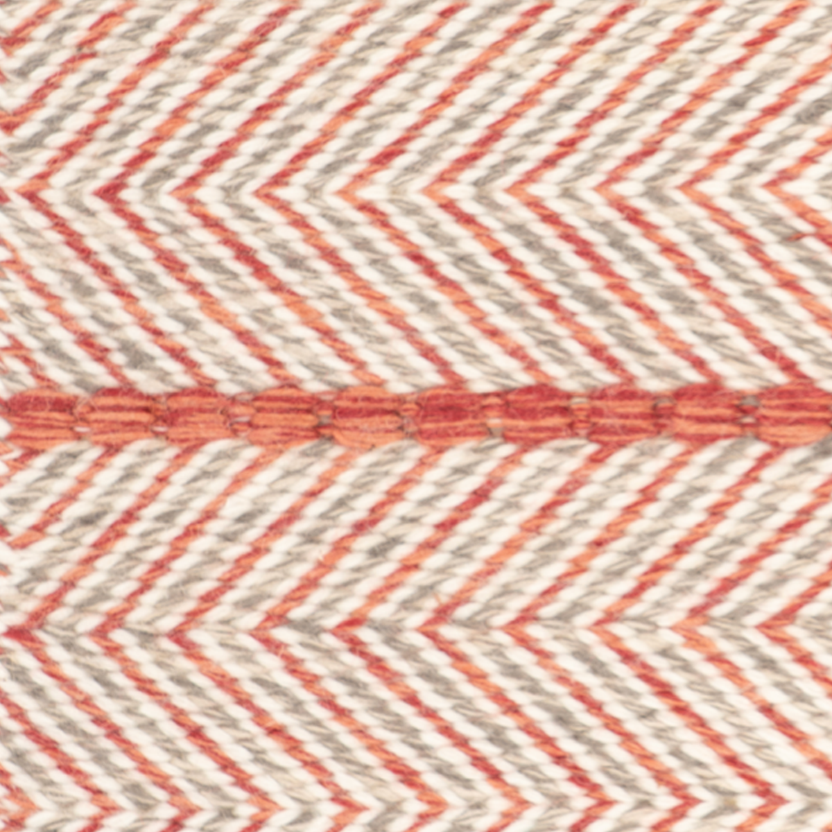 Eira : Scarlet Dawn close-up showing the wool weave and geometric motif