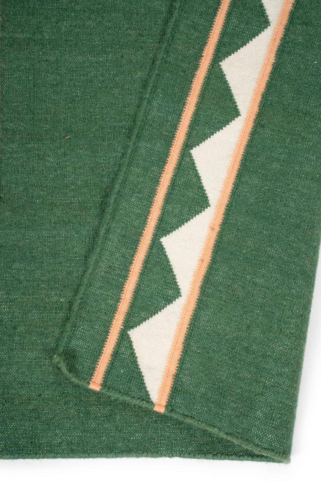 Forest Ember Dhurrie Runner detail showing edge binding and cotton finishing of the runner