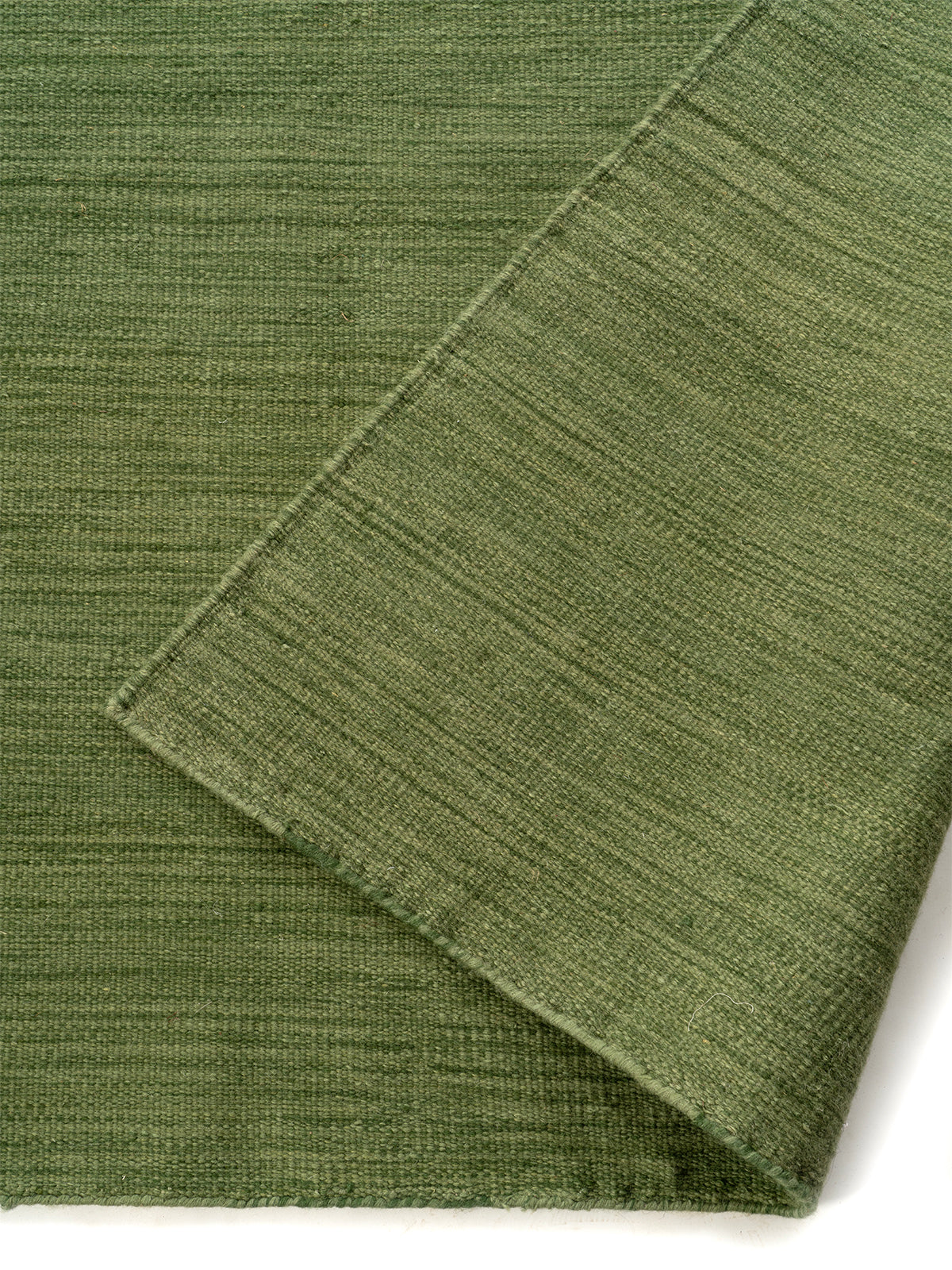 Forest Green Marl Flatweave Rug detail showing the textured wool surface and finishing