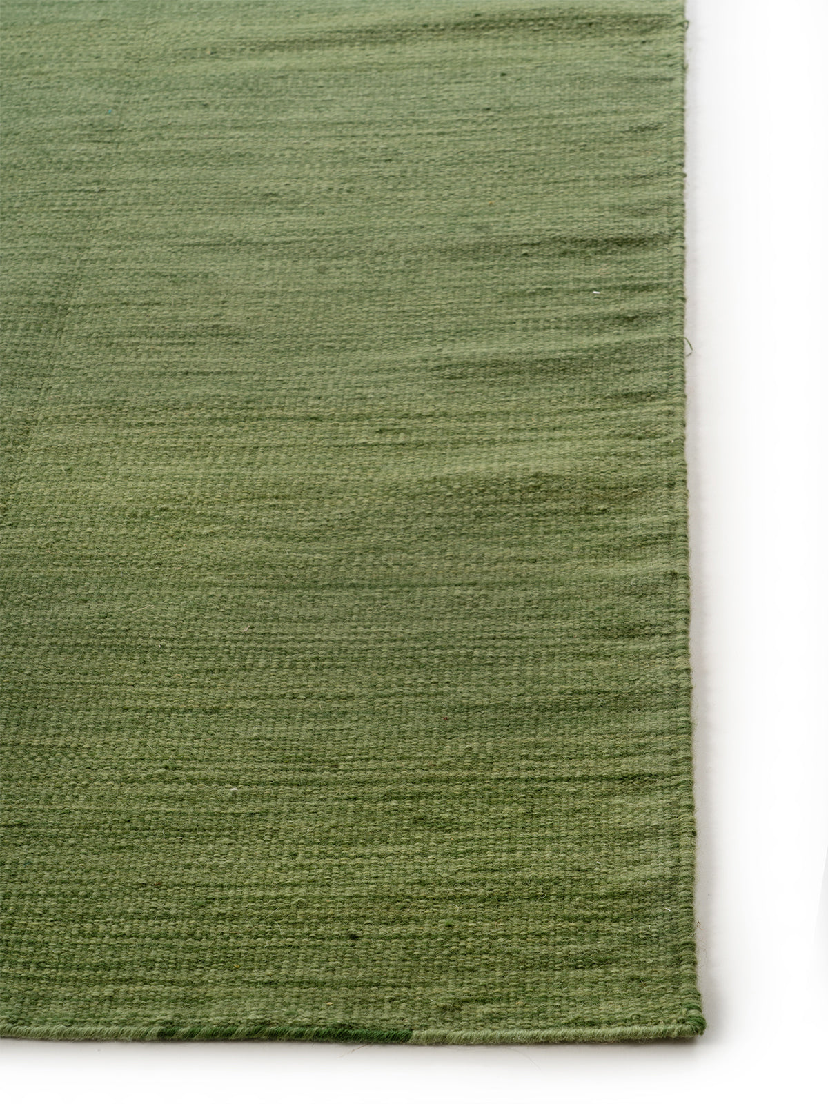 Forest Green Marl Flatweave Rug wool rug styled in a living room interior