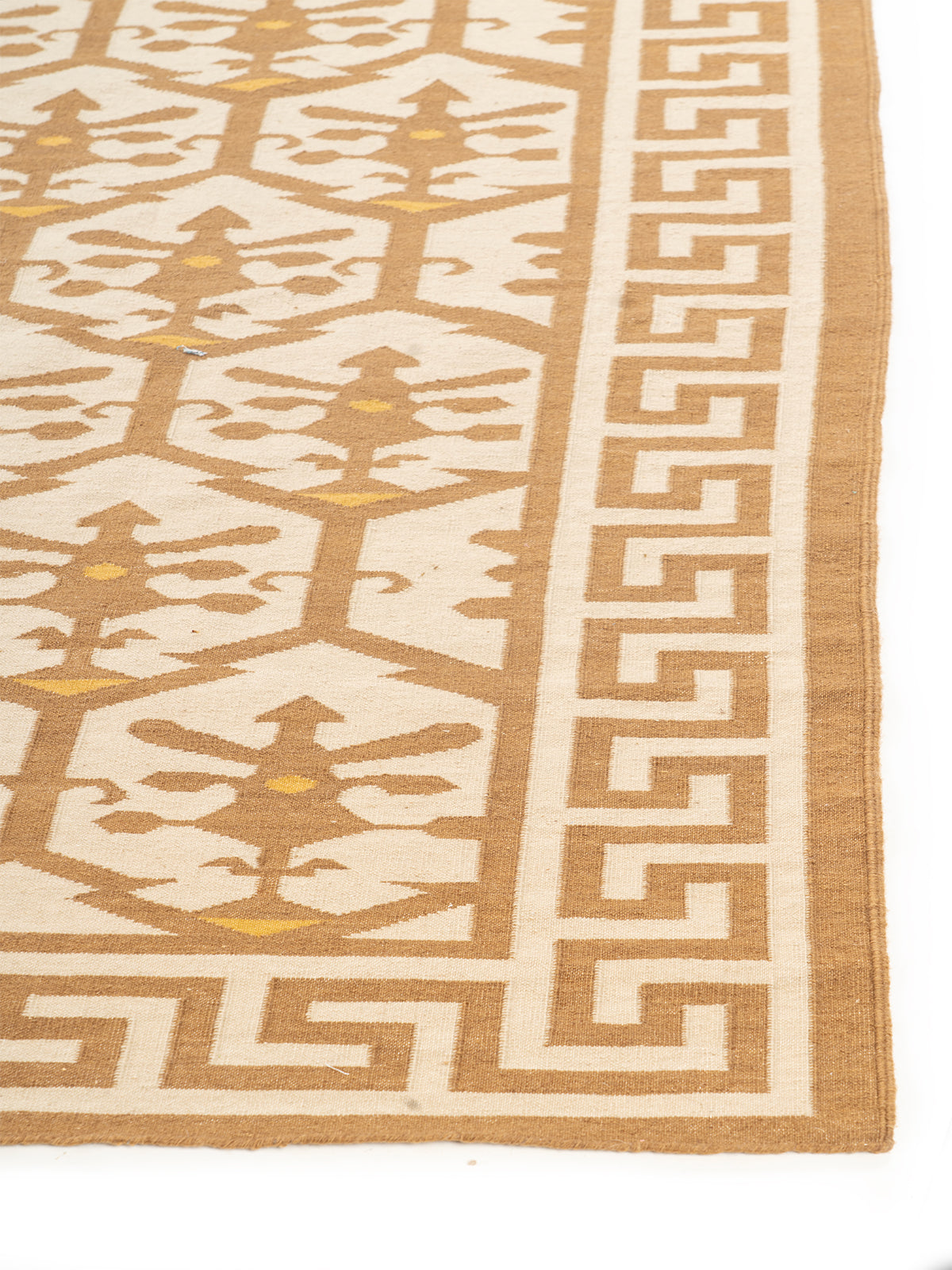 Golden Greek Vine Legacy wool rug styled in a living room interior