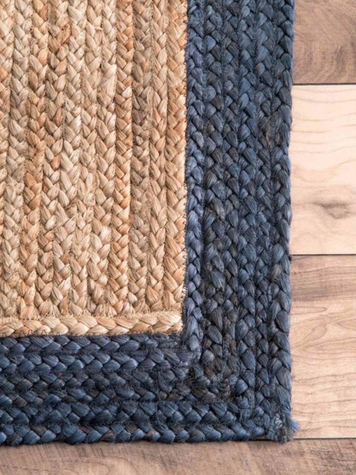 Juba jute bordered area runner-Natural jute stair runner styled on a staircase in a designed interior