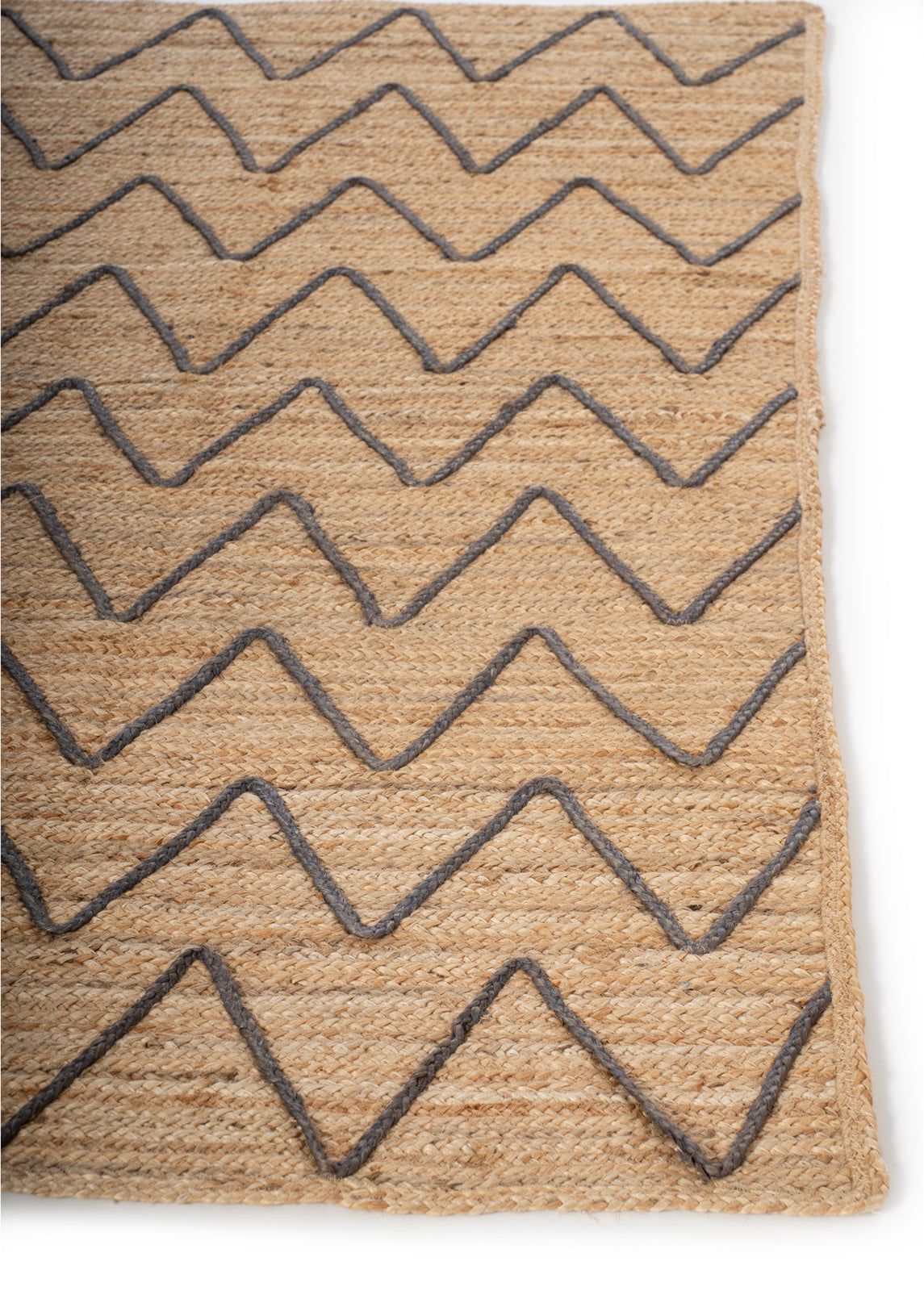 Lagos Zig Zag Braided Rug-Brown jute rug styled in a living room interior