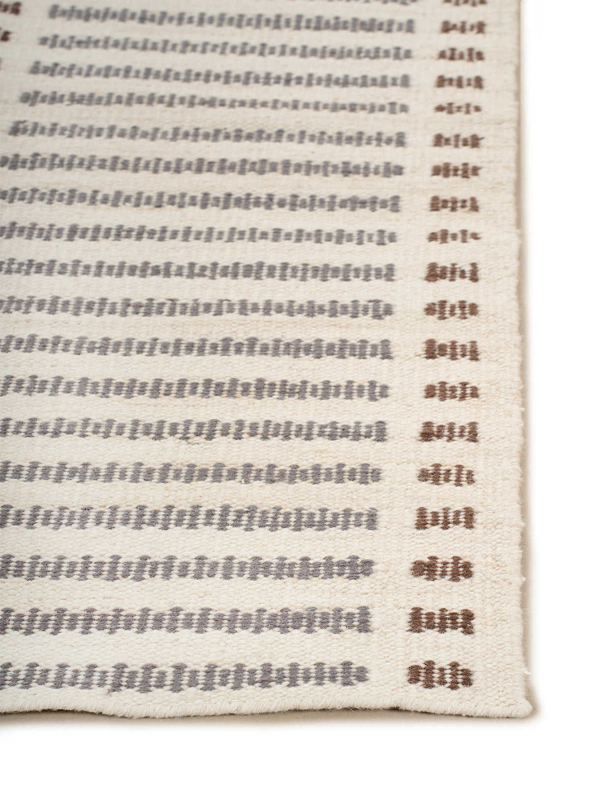 Linear Rhythm Handwoven Wool Rug wool rug styled in a living room interior
