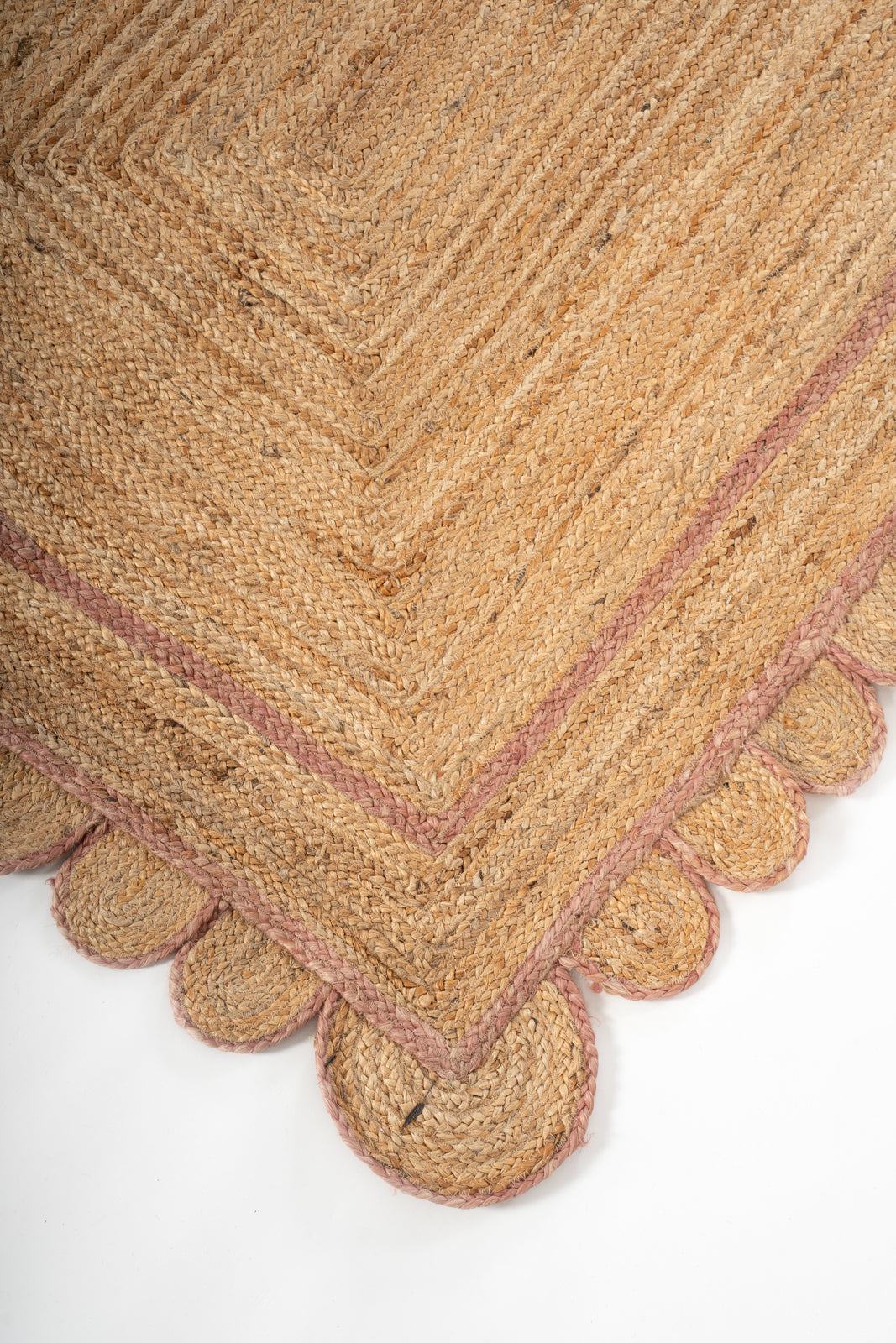 Loko scalloped jute braided area rug-Dusky Pink close-up showing the jute weave and surface texture